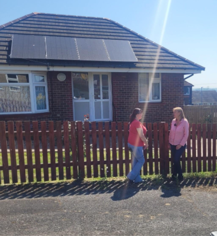 Leigh, a tenant in Hoyland, and Julia Davies, a philanthropic investor, standing outside Leigh’s home which has solar panels on the roof.
